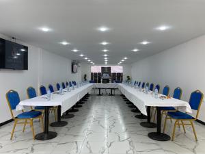 a large room with a long table and chairs at Golden H in Bejaïa