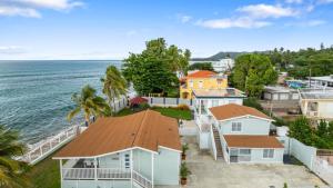 an aerial view of a coastal town with houses and the ocean at Danielas Beachfront Apartment in Rincon