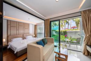 a bedroom with a bed and a large window at Private Residents in Surin Mida in Surin Beach +242 photos
