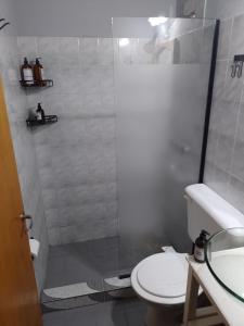 a bathroom with a shower with a toilet and a sink at Complejo Los Gringos in Villa Ciudad de America