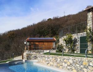 a house with a swimming pool next to a building at Cozy pool-side house with sea view in Rapallo