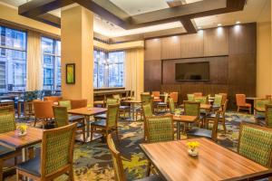a restaurant with tables and chairs and a flat screen tv at Residence Inn by Marriott Arlington Ballston in Arlington
