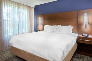 a bedroom with a large bed and a large window at Residence Inn by Marriott Sarasota Bradenton in Sarasota +16 photos