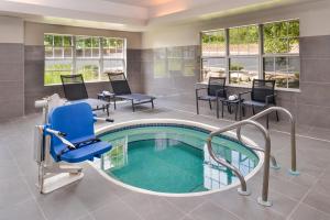 a spa room with a pool and a chair at Residence Inn by Marriott Branson in Branson