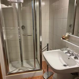 a bathroom with a shower and a sink at Locanda Il Pino in San Gimignano +46 photos