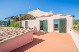 an empty auditorium with green shutters on a building at Casale Le Pitte in Casa Buraccio