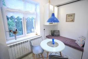 a small room with a table and a window at CERONAV CityCenter - DisneyTV!! in Galaţi
