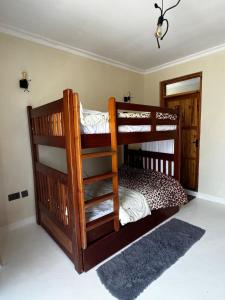a bedroom with two bunk beds in a room at Cottage Ragati in Nanyuki