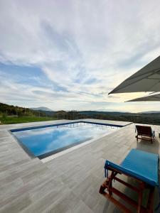 a swimming pool with a bench on a patio at Villa Panorama - Private Swimming Pool & Parking in Sarandë