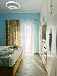 a bedroom with a bed and a large window at Villa Panorama - Private Swimming Pool & Parking in Sarandë +35 photos
