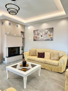 a living room with a couch and a coffee table at Villa Panorama - Private Swimming Pool & Parking in Sarandë
