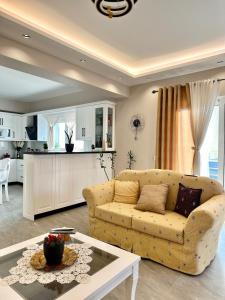 a living room with a couch and a table at Villa Panorama in Sarandë +51 photos