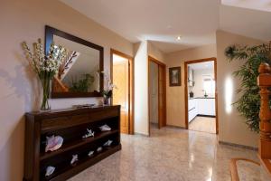 a hallway with a dresser with a mirror and a kitchen at Mallorca Casa Mar Blava in Llucmajor +25 photos