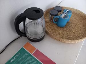 a black coffee maker and a basket with a cup at Baobab Beach Vilanculos in Vilanculos
