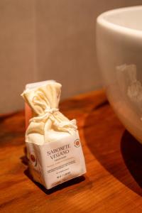 a packet of soap sitting on a table next to a cup at Casa Savana in São Paulo