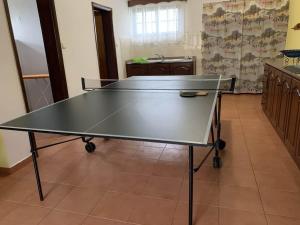 a ping pong table in the middle of a room at Quinta da Colina in São Vicente