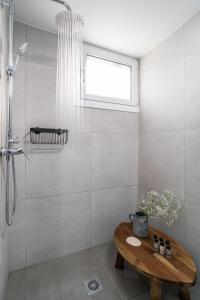 a bathroom with a shower and a wooden table at The Minion Elegant Suite - Acropolis View in Athens