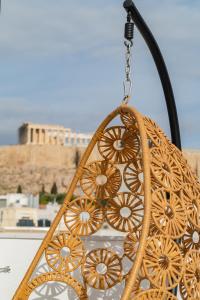 a chandelier hanging from a chain in front of a building at The Minion Elegant Suite - Acropolis View in Athens