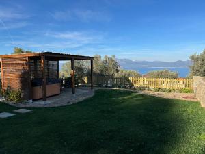 a gazebo in a yard with a green lawn at Villa Kalamos / Sea View and Pool nearby Athens in Kalamos