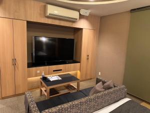 a living room with a couch and a flat screen tv at ホテル大東京 男塾ホテルグループ Adult Only in Takamatsu +38 photos