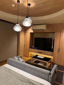 a living room with a couch and a flat screen tv at Dai Tokyo (Adult Only) in Takamatsu +17 photos