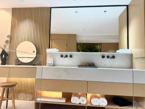 a bathroom with a sink and a mirror at Purple Stone High-End Designer Loft in Harbin