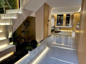 a lobby with a fish tank in the middle of a building at Purple Stone High-End Designer Loft in Harbin
