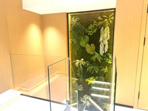 a bathroom with a walk in shower and a staircase at Purple Stone High-End Designer Loft in Harbin