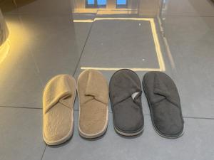 two pairs of shoes sitting on a tile floor at Purple Stone High-End Designer Loft in Harbin