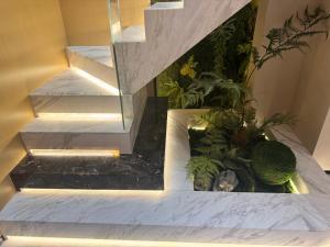 a stairway with a fish pond in a house at Purple Stone High-End Designer Loft in Harbin
