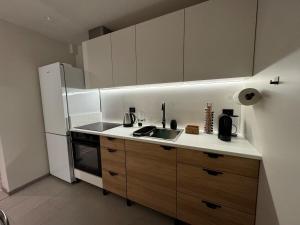 a small kitchen with a sink and a refrigerator at FjordView in Stranda