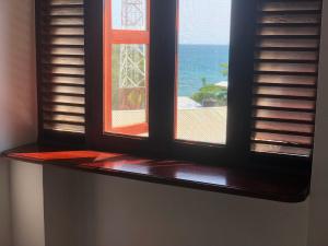 an open window with a view of the ocean at Vuga Hostel in Zanzibar City