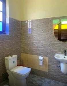 a bathroom with a toilet and a sink at Vuga Hostel in Zanzibar City +39 photos