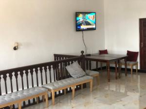 a dining room with a table and a table and chairs at Vuga Hostel in Zanzibar City