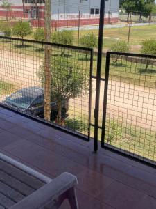 a dog behind a fence next to a bench at casa cepeda in Colón +3 photos