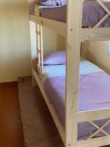 two bunk beds in a room with purple beds at casa cepeda in Colón