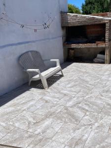 a chair sitting on a patio next to a building at casa cepeda in Colón