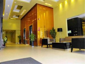 a lobby with couches and chairs in a building at Jinjiang Inn Xiamen North Railway Station Jiageng Sports Stadium in Xiamen