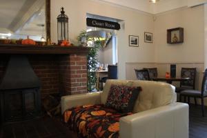 a living room with a couch and a fireplace at The Birdham Hotel & Restaurant in Bembridge +144 photos