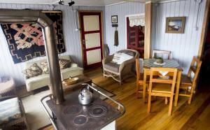a living room with a stove and a table at Casa Chiloe hostel in Castro