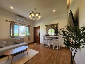 a living room with a couch and a table at 19 House in Ban Khlong Pleo