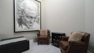 a room with a bed and a chair and a painting at Spacious & stylish upgraded 1BD Malahide Marina in Malahide