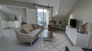 a living room with a couch and a tv at Spacious & stylish upgraded 1BD Malahide Marina in Malahide