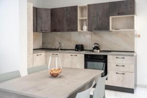 a kitchen with a table with a vase on it at 2 bedroom apartment in gudja in Gudja