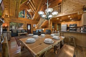 a dining room and living room of a log cabin at Mountain Paws #526 in Sevierville