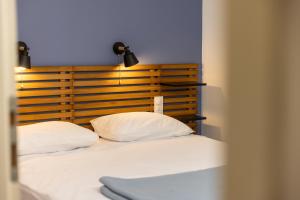 a bed with two white pillows in a room at Camping Alpes Dauphiné in Gap