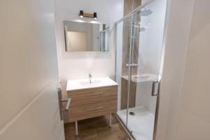 a bathroom with a sink and a shower at Camping Alpes Dauphiné in Gap