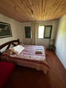 ein Schlafzimmer mit einem Bett mit Holzdecke in der Unterkunft Posada en la Playa in Barra del Chuy