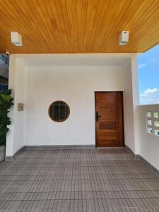 an empty room with a door and a tile floor at 19 House in Ban Khlong Pleo +5 photos
