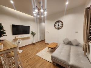 a living room with a couch and a table at 19 House in Ban Khlong Pleo